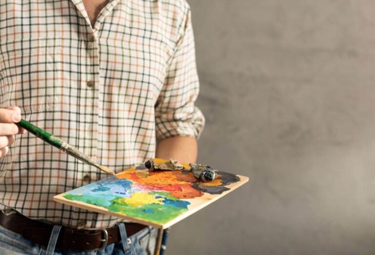 Male artist holding palette and paintbrush man art MAL7H2M.jpg